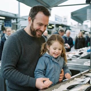 Un padre e sua figlia davanti al banco del pesce